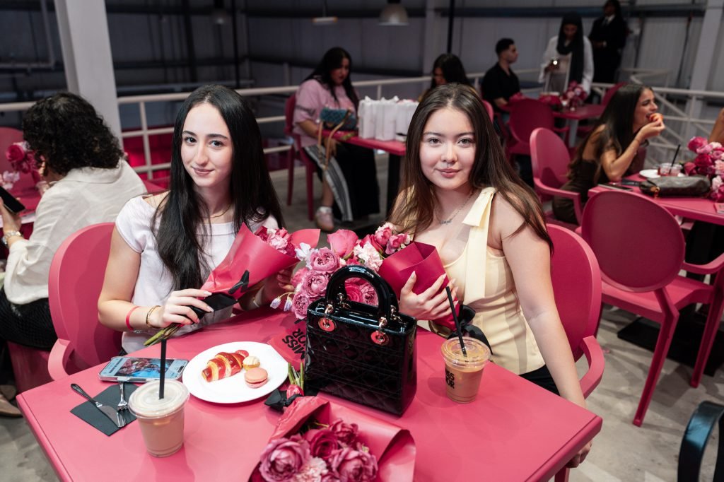 Guests with iced lattes and pastries at the Miss Dior Café